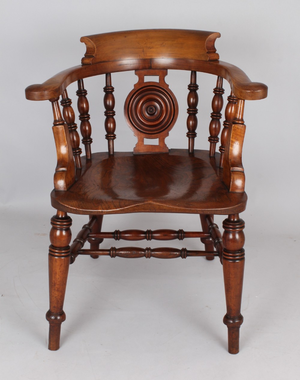 A pair of 19th-century satin birch smokers bow armchairs featuring turned spindles, central carved roundel splats, and shaped wooden seats. View II