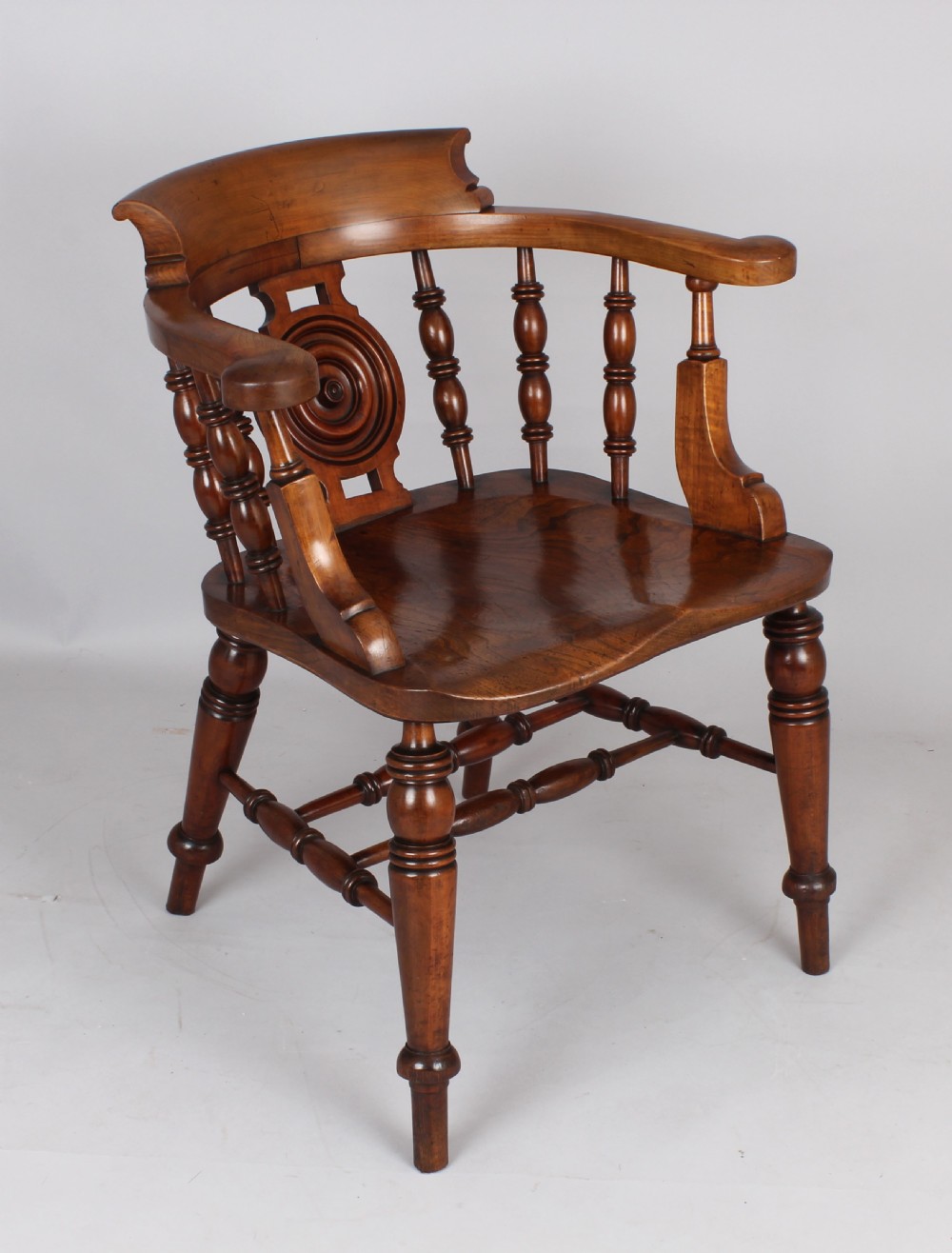 A pair of 19th-century satin birch smokers bow armchairs featuring turned spindles, central carved roundel splats, and shaped wooden seats. View III