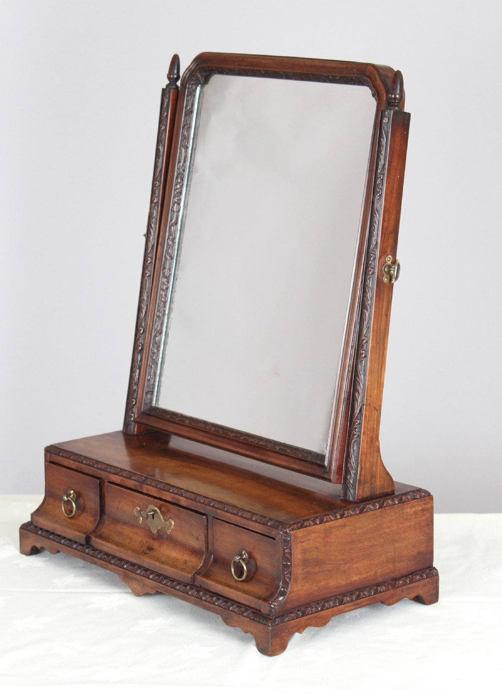 A mahogany dressing table toilet mirror with exceptional carved detail;