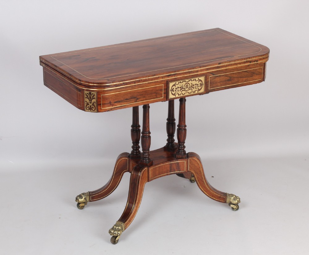 Regency rosewood D-shaped games table with a revolving top