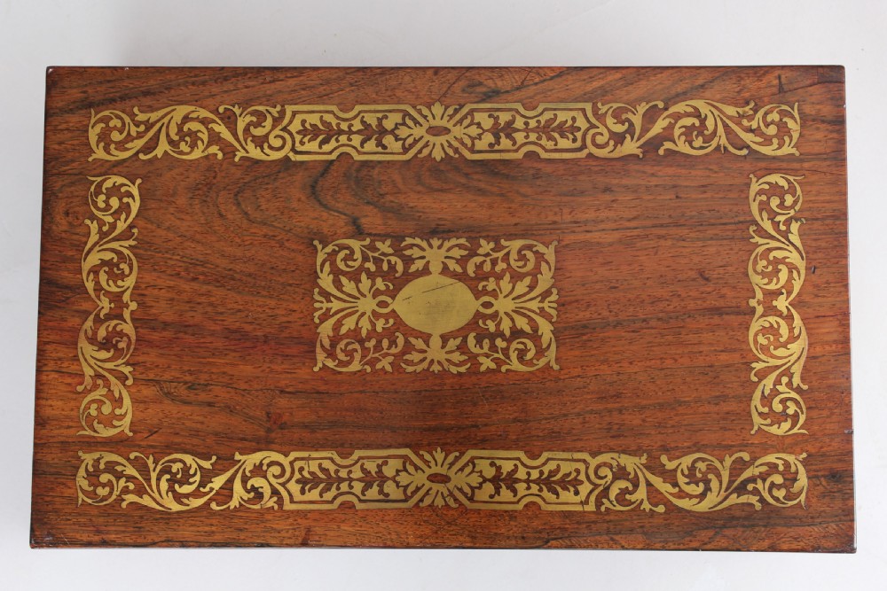An open early Victorian rosewood games compendium featuring small wooden drawers, a green velvet playing surface, and a red gilt-tooled backgammon interior section. View IV