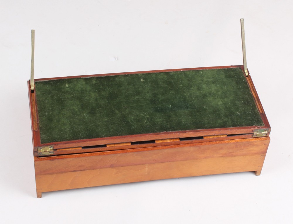 An open early Victorian rosewood games compendium featuring small wooden drawers, a green velvet playing surface, and a red gilt-tooled backgammon interior section. View VI