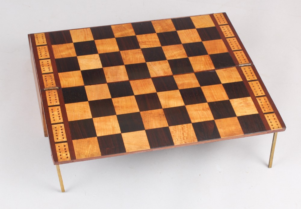 An open early Victorian rosewood games compendium featuring small wooden drawers, a green velvet playing surface, and a red gilt-tooled backgammon interior section. View VII