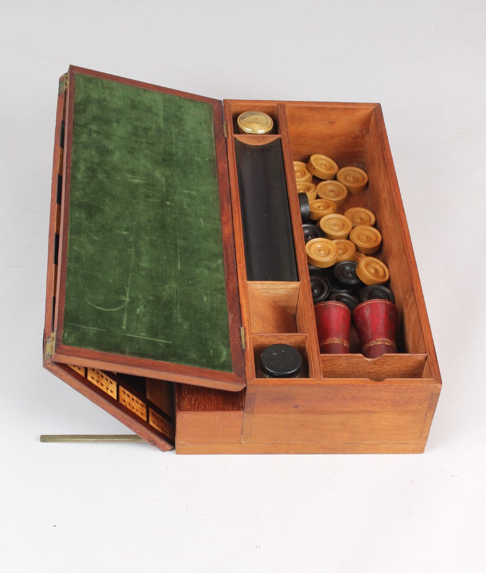 An open early Victorian rosewood games compendium featuring small wooden drawers, a green velvet playing surface, and a red gilt-tooled backgammon interior section. View IX