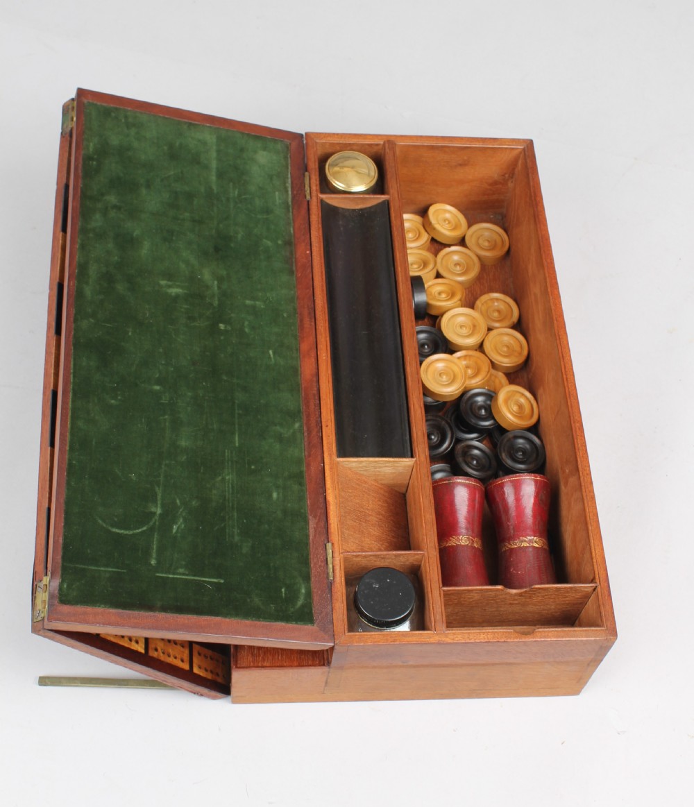An open early Victorian rosewood games compendium featuring small wooden drawers, a green velvet playing surface, and a red gilt-tooled backgammon interior section. View XI