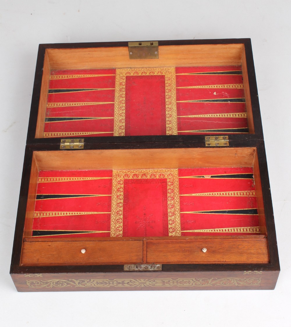 An open early Victorian rosewood games compendium featuring small wooden drawers, a green velvet playing surface, and a red gilt-tooled backgammon interior section. View XIII