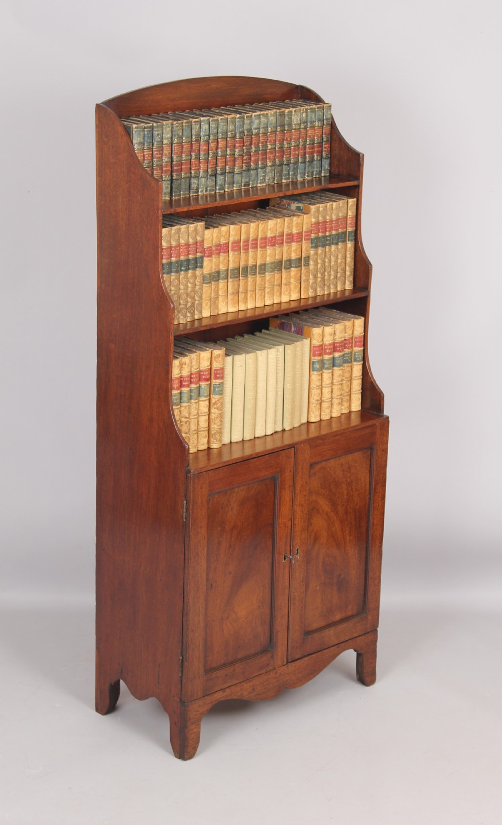 Small mahogany cupboard based waterfall open bookshelves View III