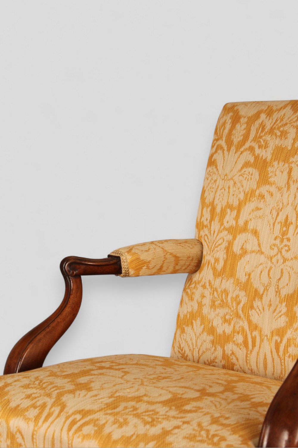 A mid-18th-century Georgian open armchair crafted from dark mahogany, featuring cabriole front legs, swept rear legs, and gold-yellow damask upholstery. View II