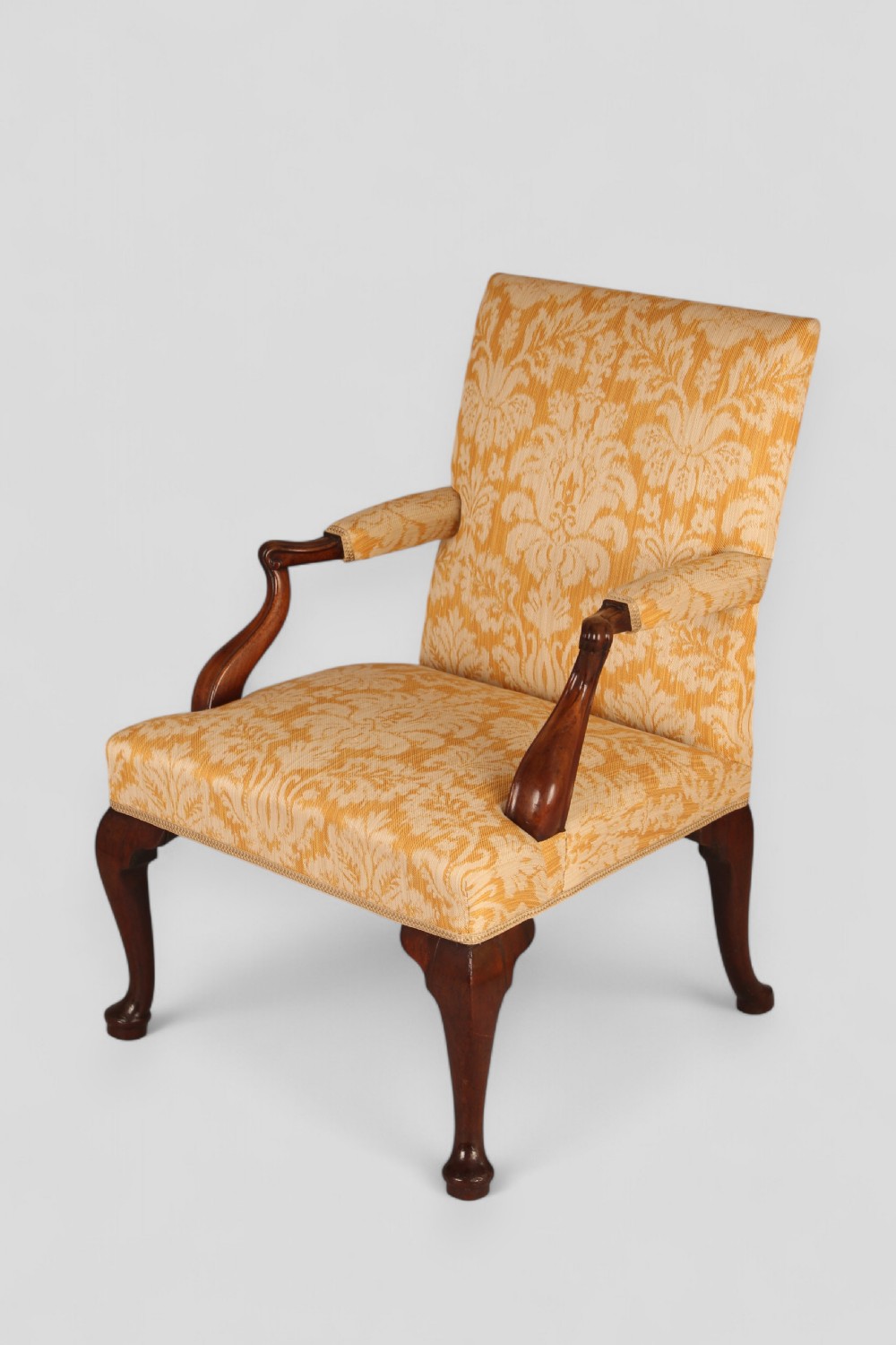 A mid-18th-century Georgian open armchair crafted from dark mahogany, featuring cabriole front legs, swept rear legs, and gold-yellow damask upholstery. View III