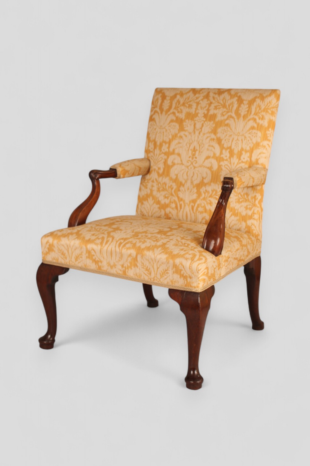 A mid-18th-century Georgian open armchair crafted from dark mahogany, featuring cabriole front legs, swept rear legs, and gold-yellow damask upholstery. View IV