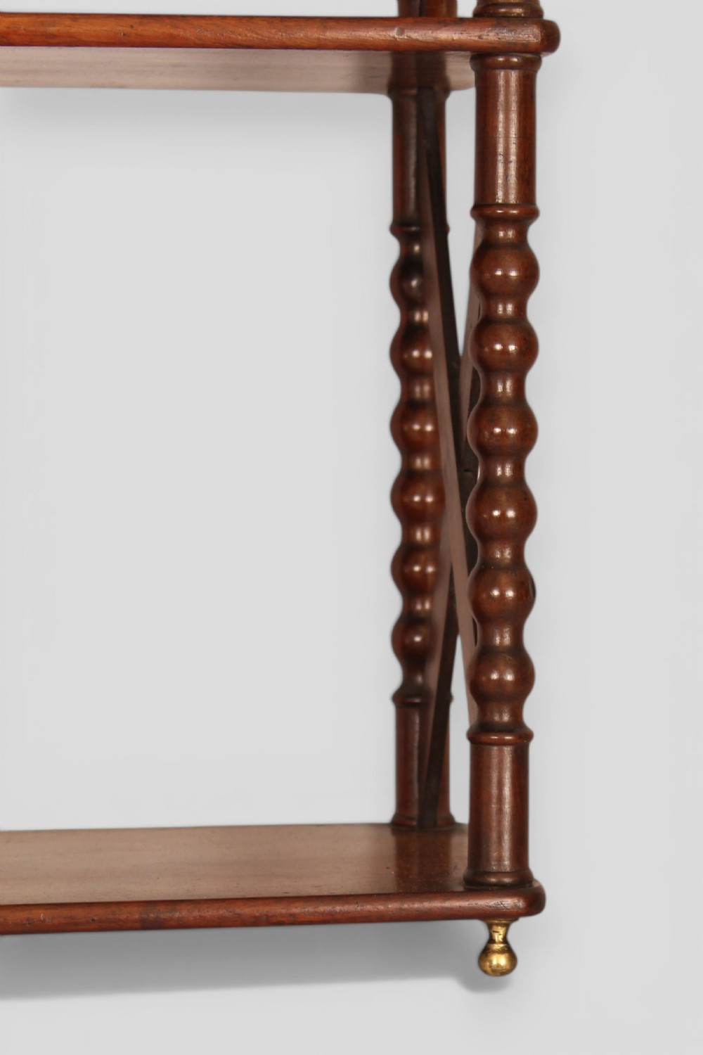 A four-tier dark mahogany hanging shelf unit featuring bobbin-turned vertical posts, X-frame lattice sides, and top brass hanging fixtures. View II