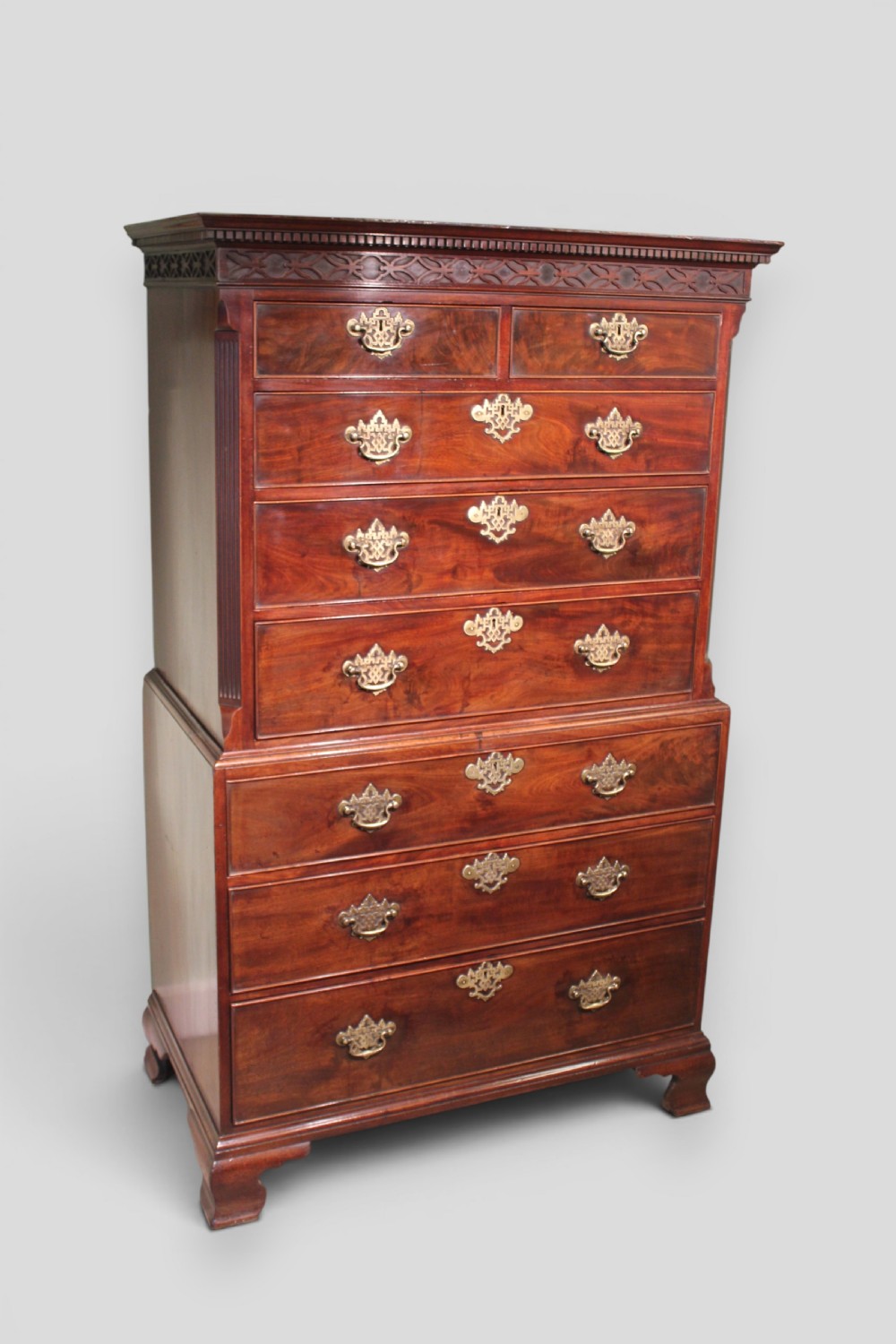 An eighteenth-century mahogany tallboy chest-on-chest featuring a carved frieze, brass swan-neck handles, and bracket feet. View III