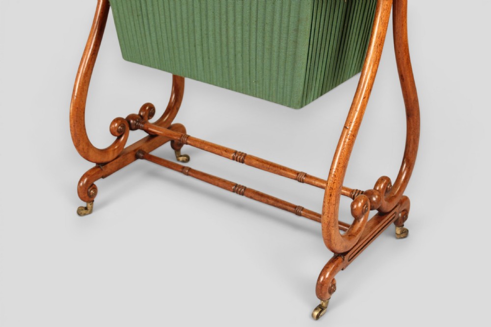 A Regency mahogany work table featuring a single drawer above a pleated green fabric basket, supported by lyre-shaped ends and a double stretcher with castors. View IV