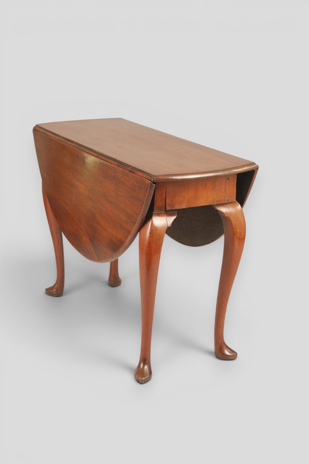 A small mahogany drop-leaf table featuring two hinged circular side flaps and four slender cabriole legs ending in pad feet. View III