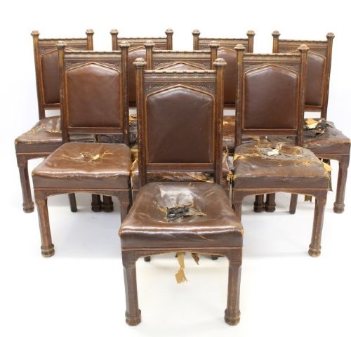 Set of six Gothic Revival oak dining chairs featuring pointed arch upholstered backs, carved cresting, turned finials, and white fabric upholstery. View XI