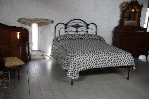 fig 1. Striking and individual Early black all iron no foot end kingsize bed