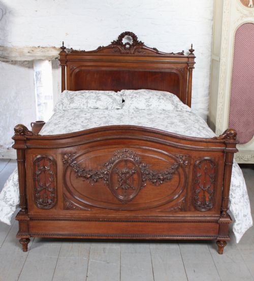 fig 1. Beautifully carved French Louis XV1 style walnut and mahogany king size bed