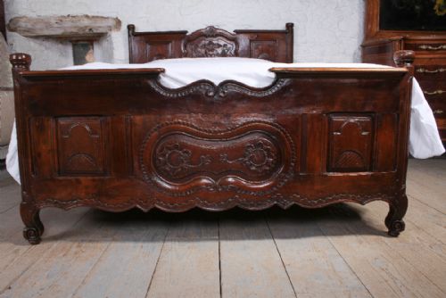 fig 1. Lovely solid carved dark cherry Provencale king size bed with shaped panels and foliate carving.