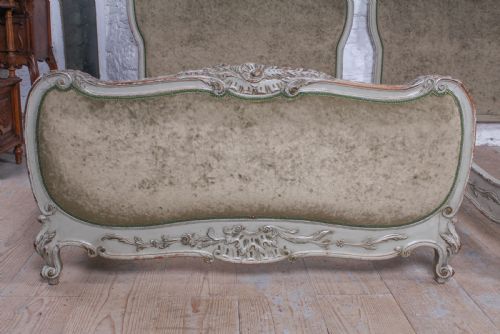 fig 1. A pair of French Louis XV style single bed frames with carved grey painted timber and olive green velvet upholstered panels.