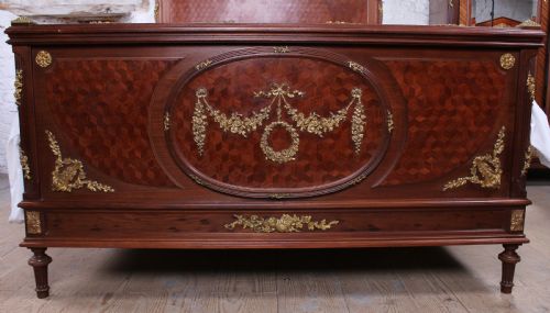 fig 1. Magnificent mahogany and fruit wood parquetry king size bed with striking ormolu decoration.