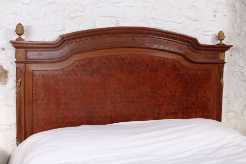 fig 2. Magnificent mahogany and fruit wood parquetry king size bed with striking ormolu decoration.