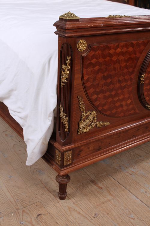 fig 3. Magnificent mahogany and fruit wood parquetry king size bed with striking ormolu decoration.