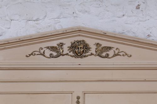 fig 2. An off-white painted French king-size bedstead featuring gilt metal mounts, torch motifs, and carved claw feet.