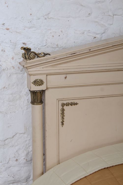 fig 3. An off-white painted French king-size bedstead featuring gilt metal mounts, torch motifs, and carved claw feet.