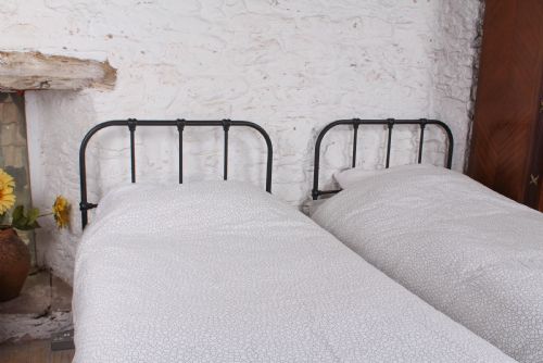 fig 2. Lovely simple pair of Staples utilitarian single iron beds (can be joined)