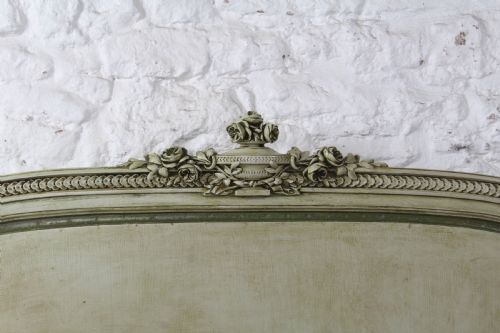 fig 3. A French Louis XVI style king size bedstead in distressed sage green paint with carved fluted posts and decorative molding.
