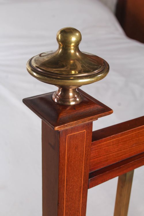 fig 3. An antique mahogany double bed frame featuring polished brass upright spindles, brass urn finials, and an oval marquetry medallion inlaid on the footboard.
