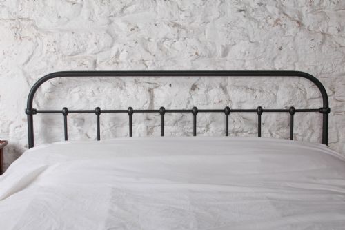 fig 2. A black painted iron double bed frame featuring a vertical spindle headboard and matching footboard.