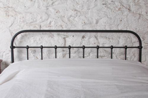 fig 3. A black painted iron double bed frame featuring a vertical spindle headboard and matching footboard.