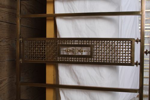 fig 3. An antique French brass double bed frame with ornamental lattice headboard and footboard panels, vertical spindles, and finial corner posts.