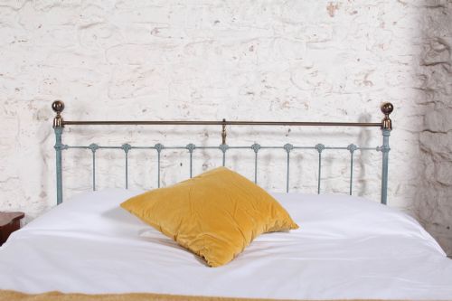 fig 1. A Victorian king-size light blue painted iron bedstead featuring a straight brass top rail with polished brass corner finials.