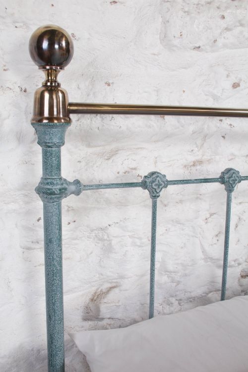 fig 2. A Victorian king-size light blue painted iron bedstead featuring a straight brass top rail with polished brass corner finials.