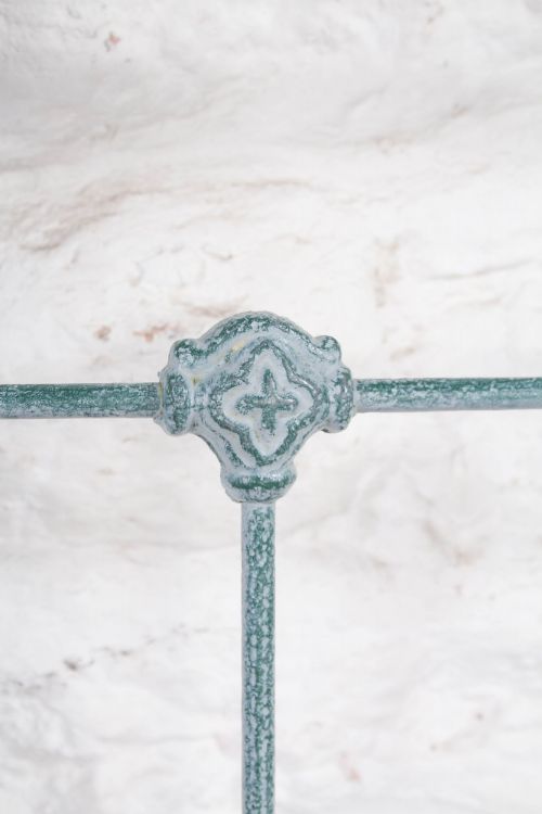 fig 3. A Victorian king-size light blue painted iron bedstead featuring a straight brass top rail with polished brass corner finials.