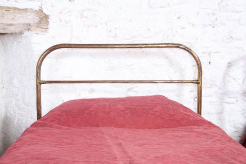 fig 3. A pair of antique tubular brass single bed frames featuring rounded headboards, simple footboards, turned leg details, and brass castors.