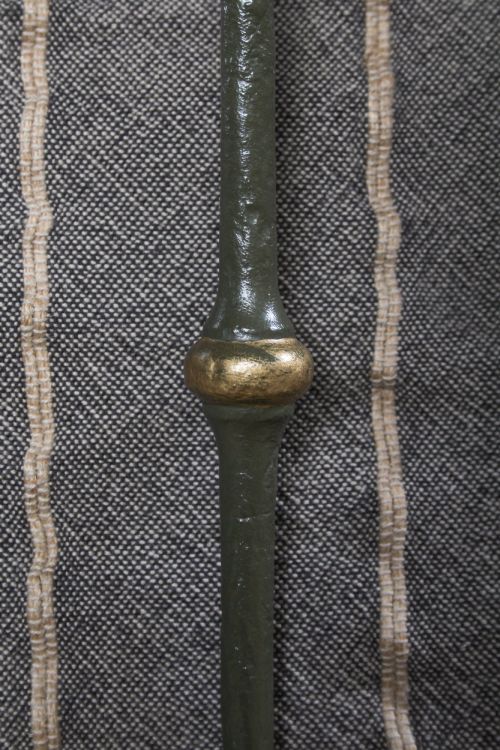 fig 3. A dark green painted iron and brass king-size bedstead featuring vertical iron spindles and polished brass top rails.
