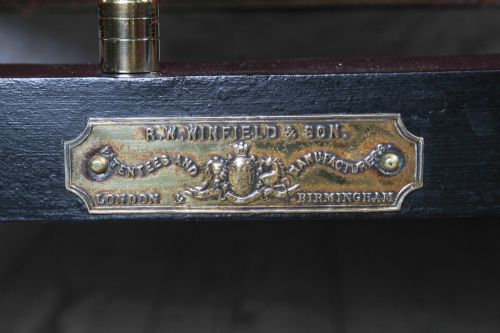 fig 2. A Victorian iron and brass king-size bedstead featuring barley twist posts, ornate brass scrollwork on the footboard, and a arched black iron headboard.