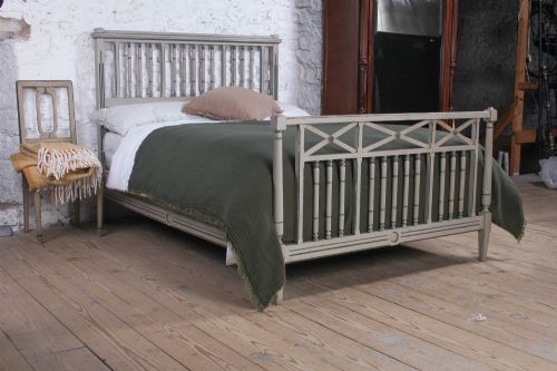 fig 1. A grey painted French Arts and Crafts double bedstead featuring vertical spindle detailing and a patterned footboard.