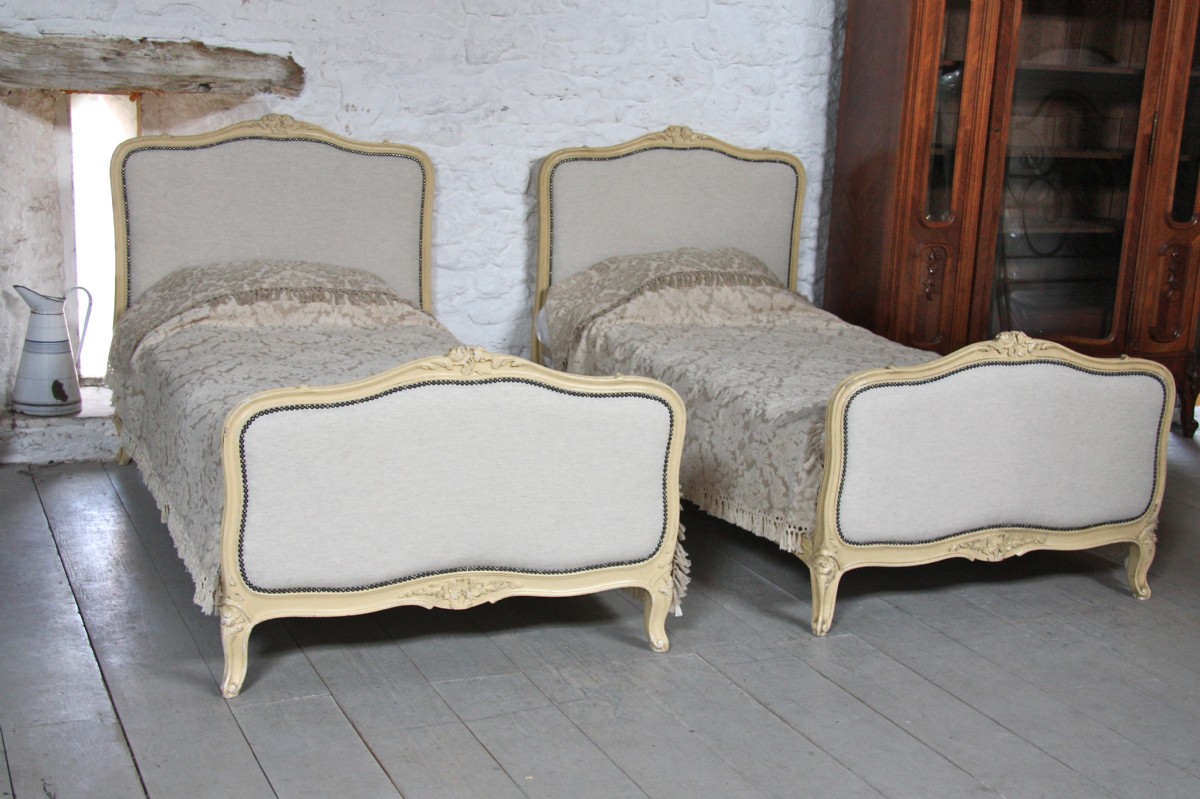 Fully reupholstered in Laura Ashley plain Linen, pair of single French Louis XV painted beds