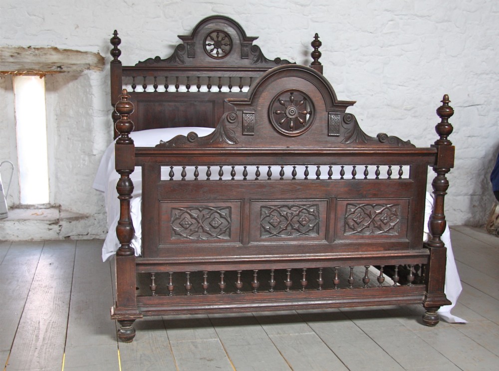 Carved French Bretton dark oak bed with bedside
