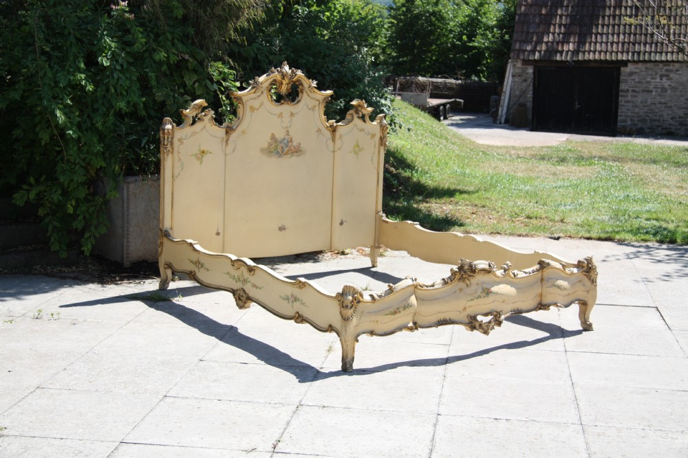 Painted and gilded very ornate Italian bed with low foot end 