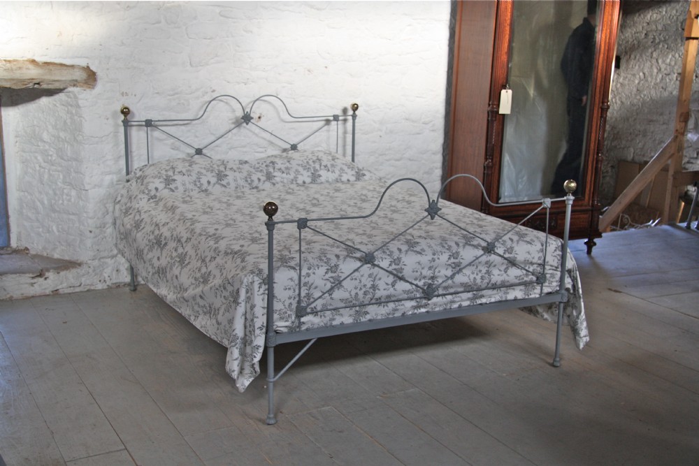 Pretty English iron king size bed with brass knobs in mid lead grey