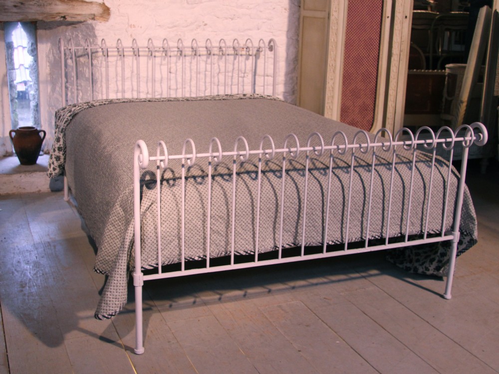 Attractive unusual simple forged iron king size bed with curl detail.