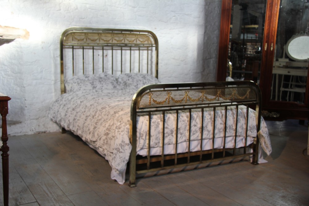IndividualFrench all brass bed with decorative garlands
