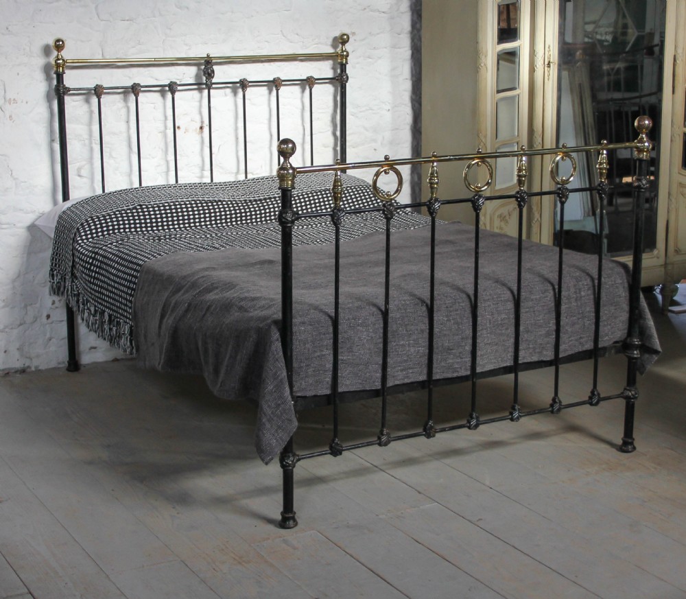 All original black and brass bed with rings and spindles detail
