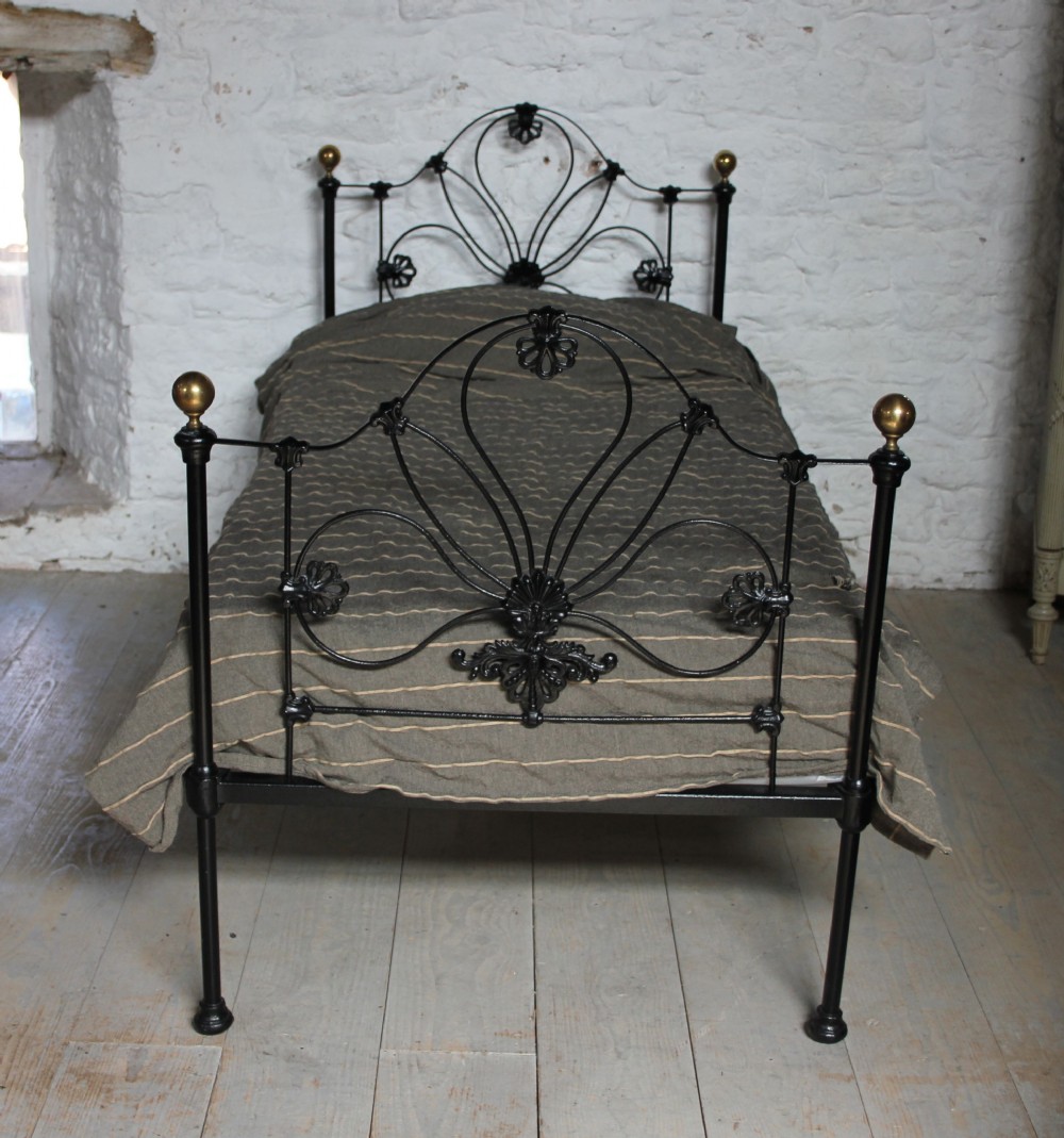 Pretty early black and brass single Victorian bed