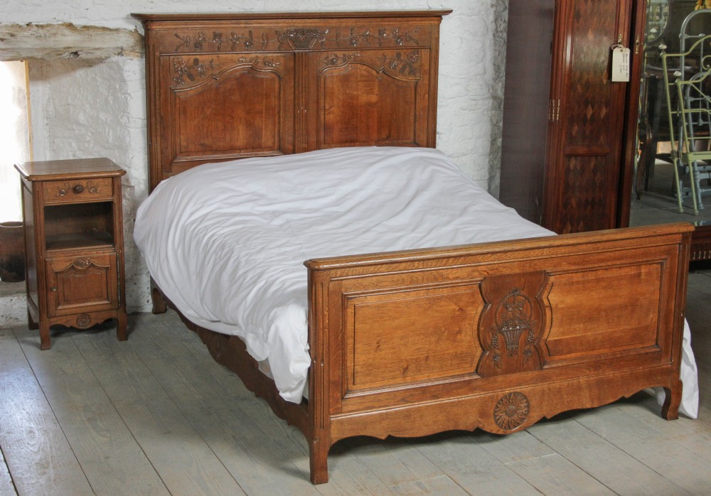 French carved oak double bed with matching pair of bedsides